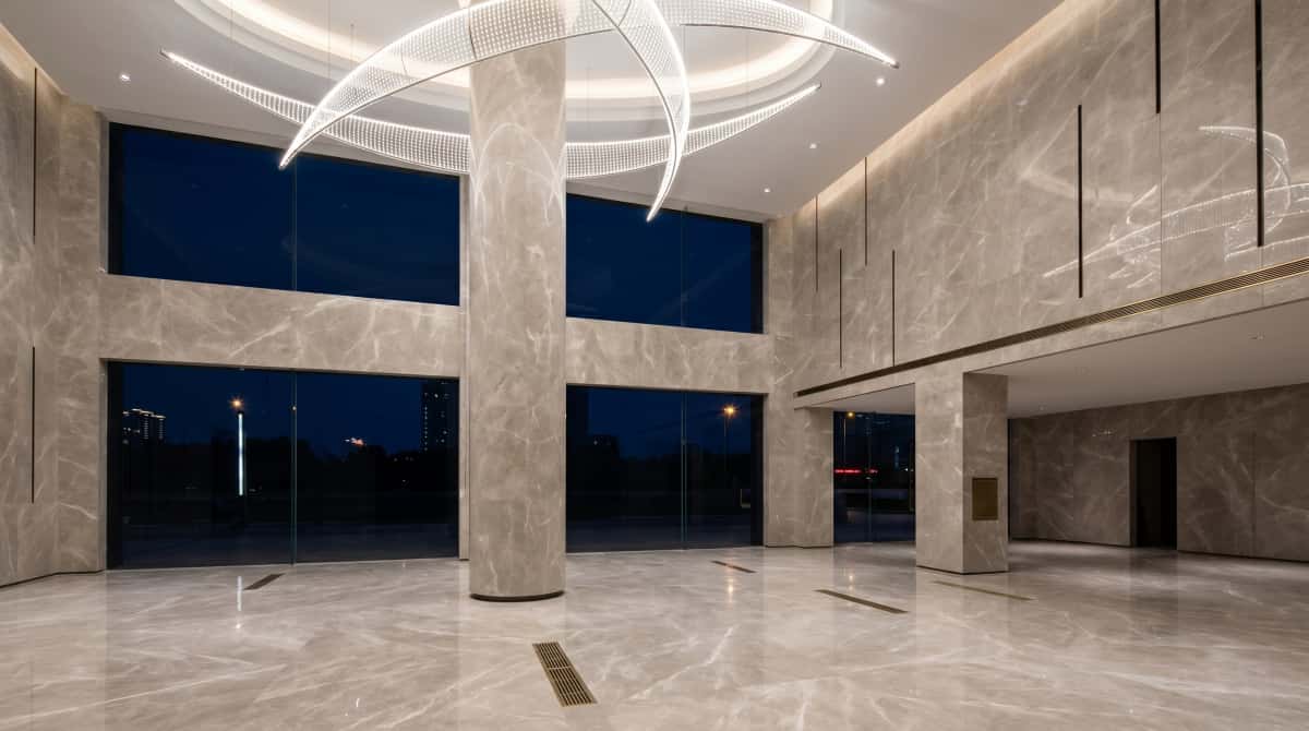 Large interior floor finished with polished Turkish beige-grey marble