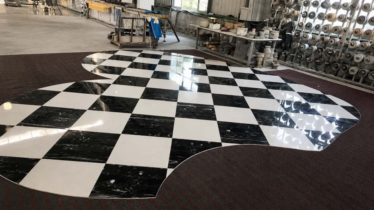 Black and white checkerboard marble floor pattern pre-arranged in Aoli Stone factory