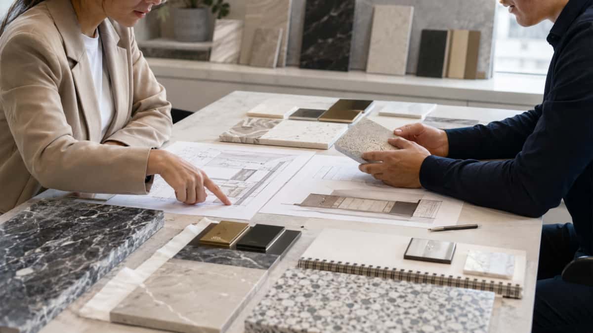 Architect and buyer reviewing stone samples for different project areas