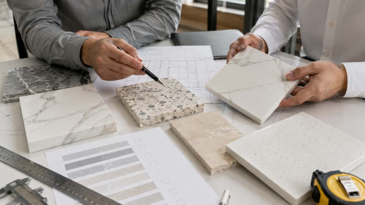 stone-project-material-consultation Project buyer reviewing stone samples drawings and material options with supplier