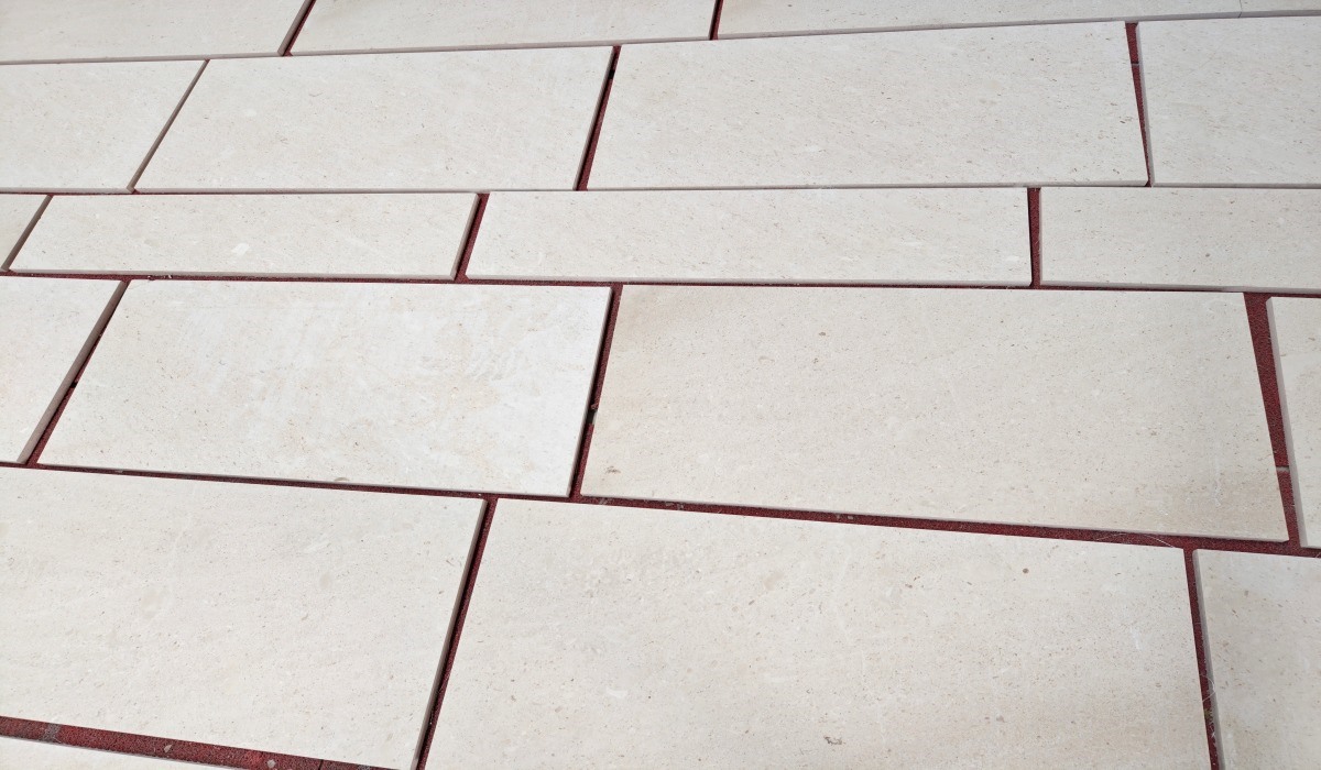 Cotswold Cream limestone tiles arranged for dry lay inspection before project packing