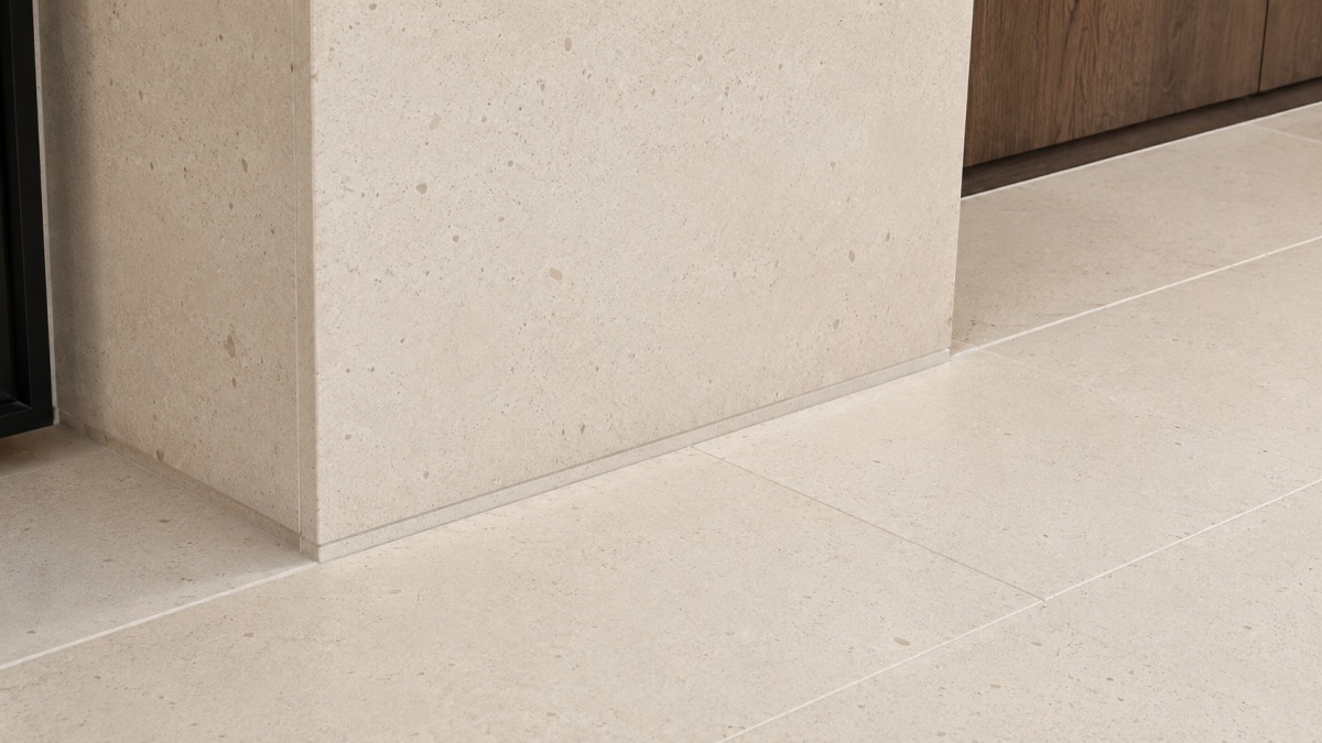 Cotswold Cream limestone floor tiles arranged in a project layout, showing warm cream beige tone, fine fossil texture, subtle color variation, and matte natural surface