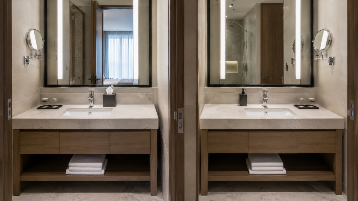 Repeated hotel bathroom stone vanity tops with consistent cutouts edges and dimensions